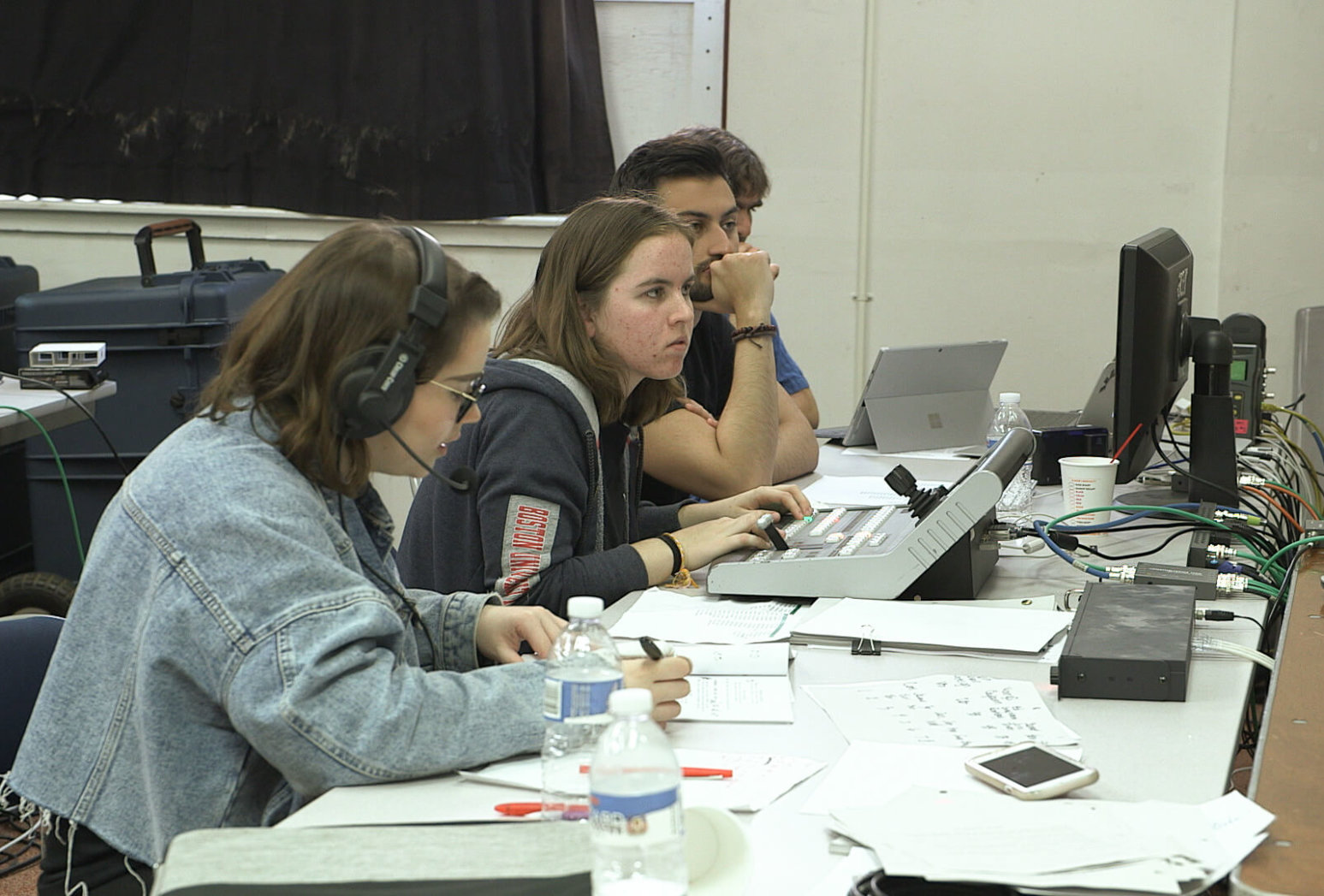 Director and crew in production booth